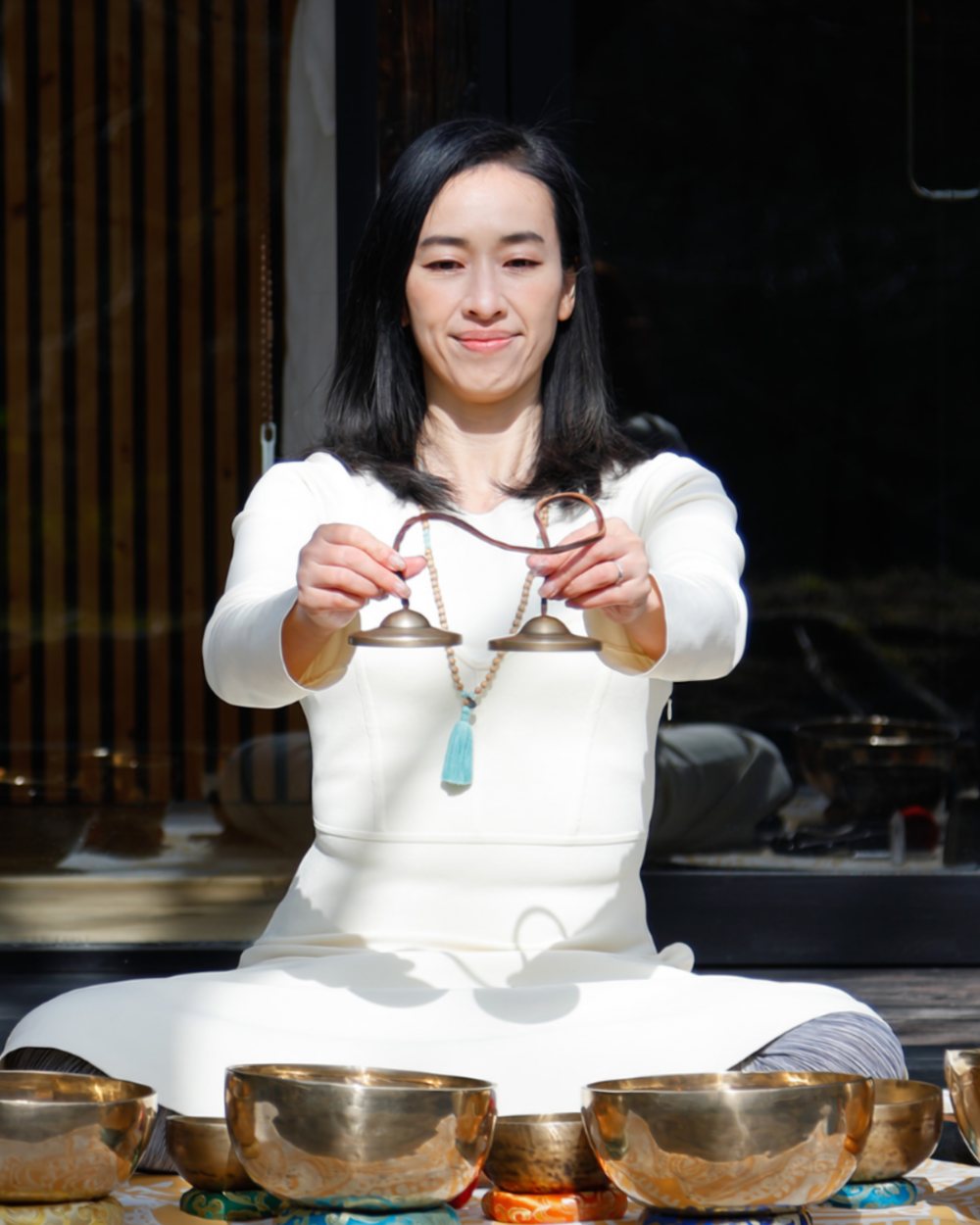 A ZENSEE therapist with singing bowls